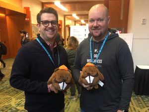 People at WordCamp US with stuffed beavers.
