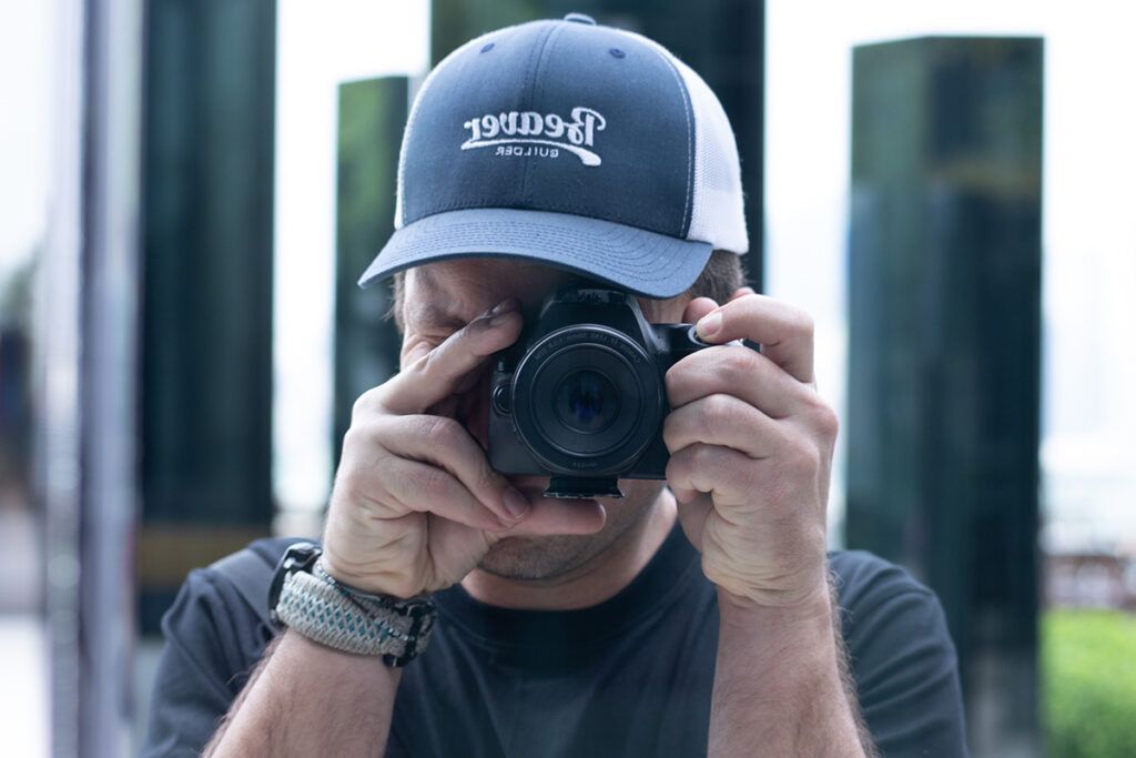 Robby holding a camera taking a self portrait.